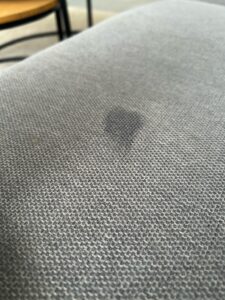 moisture trapped in couch fabric causing odor
