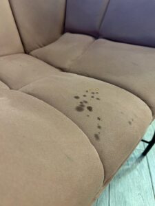 Water soaking into couch cushions and upholstery layers 