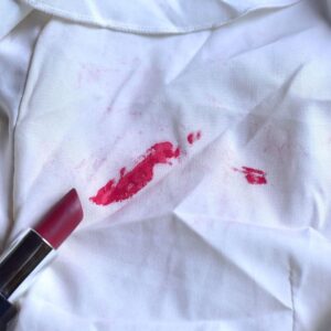 Makeup smudge on a fabric couch cushion before cleaning