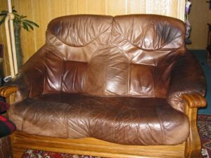 Body oil buildup darkening fabric on couch armrest
