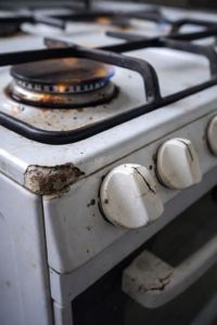 A close-up of a stove showing a small cosmetic defect, suggesting a potential safety risk beneath the surface